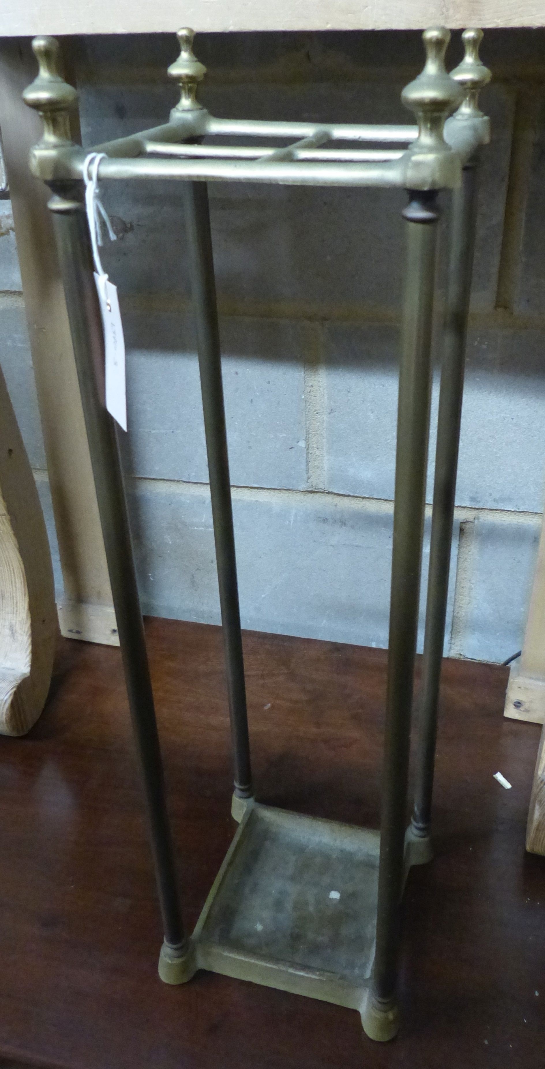 A tubular brass four division stick stand, H.66cm